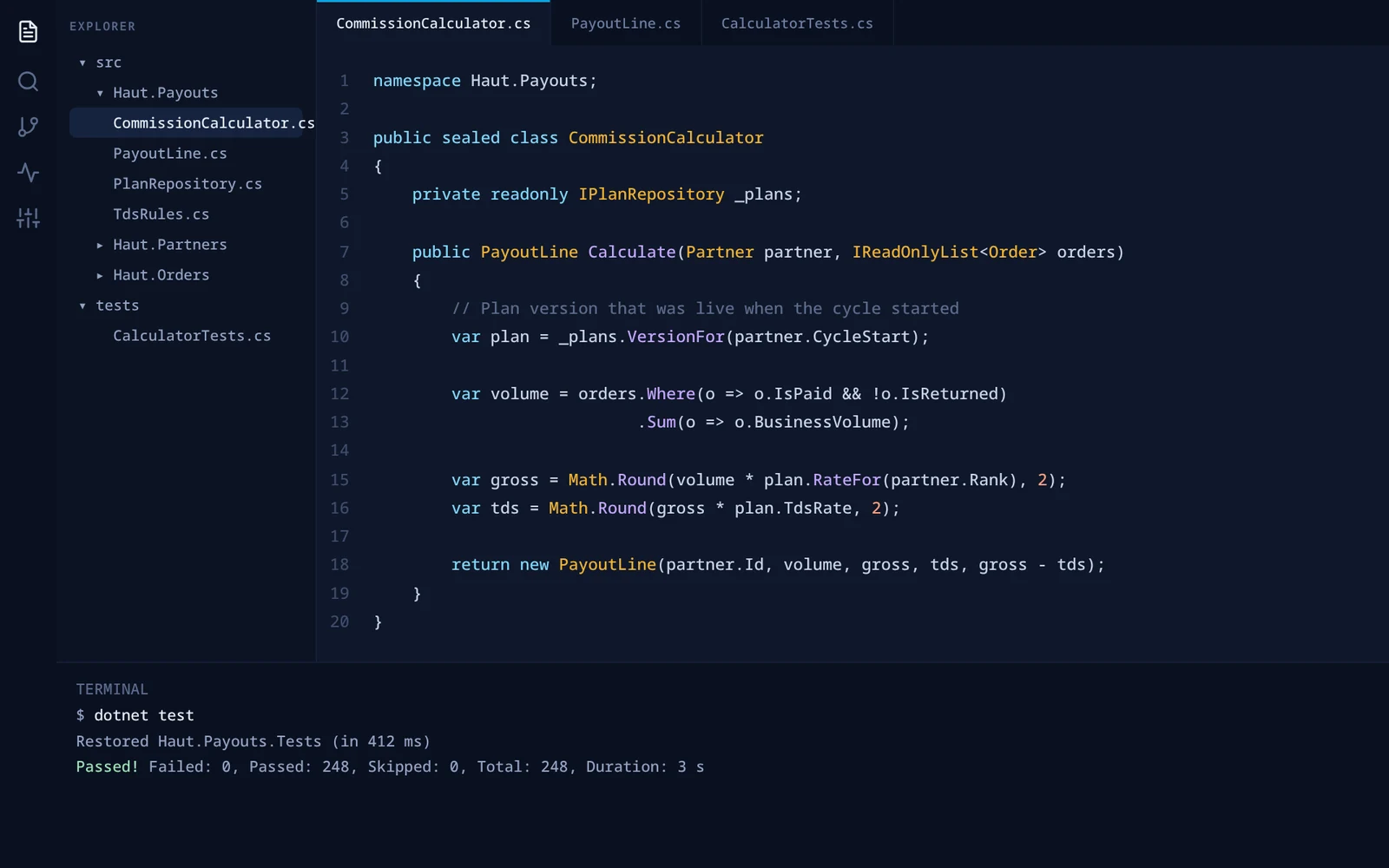 Code editor showing a commission calculator class and passing tests